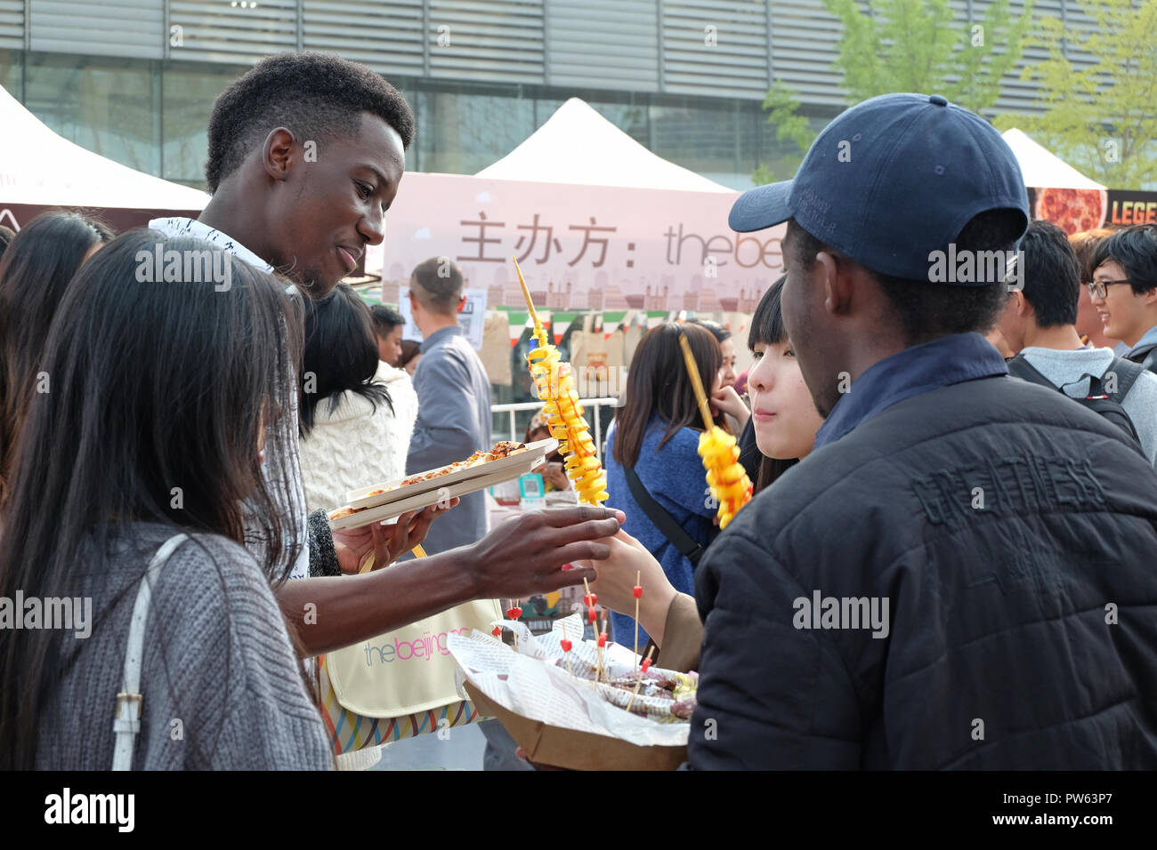 Beijing, China - October 13,2018: Expats and locals enjoying 2018 Beijing Pizza Festival at the Zhongguancun Software Park, Beijing, China. Fifth annual Beijing Pizza Festival on Oct 13-14 festival organized by The Beijinger - free monthly listings and entertainment website and magazine produced by True Run Media in Beijing, China. Stock Photo
