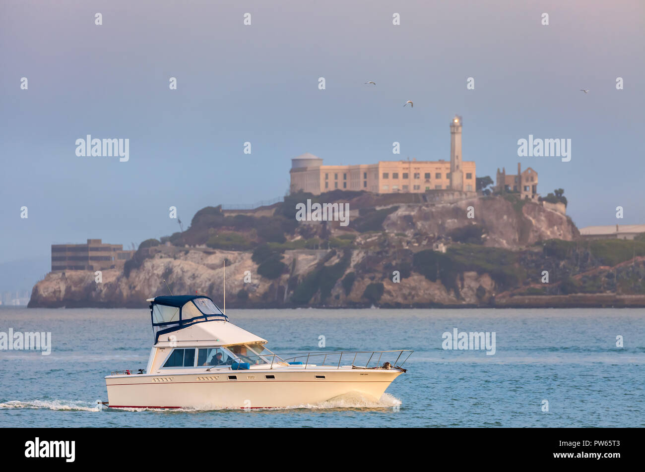 A fishing boat pass through San Francisco Bay at early morning, with ...