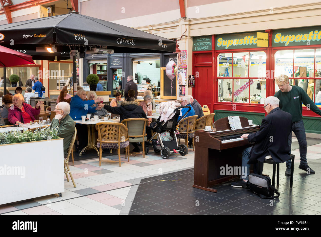 Man playing a piano in the Grainger Market, Newcastle upon Tyne, England, UK Stock Photo
