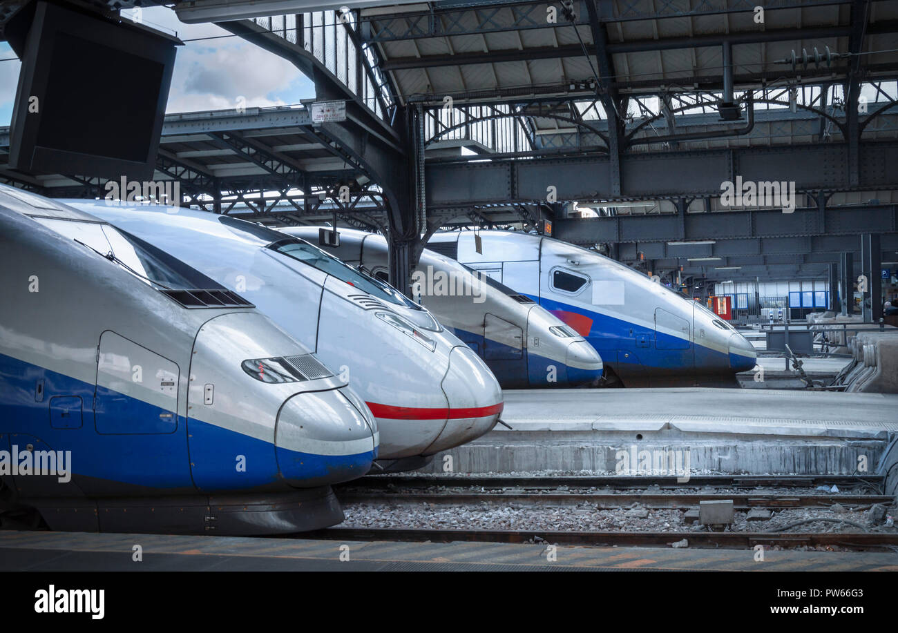 Four different types of high-speed modern trains, stationed in the train station from Paris, France. Stock Photo