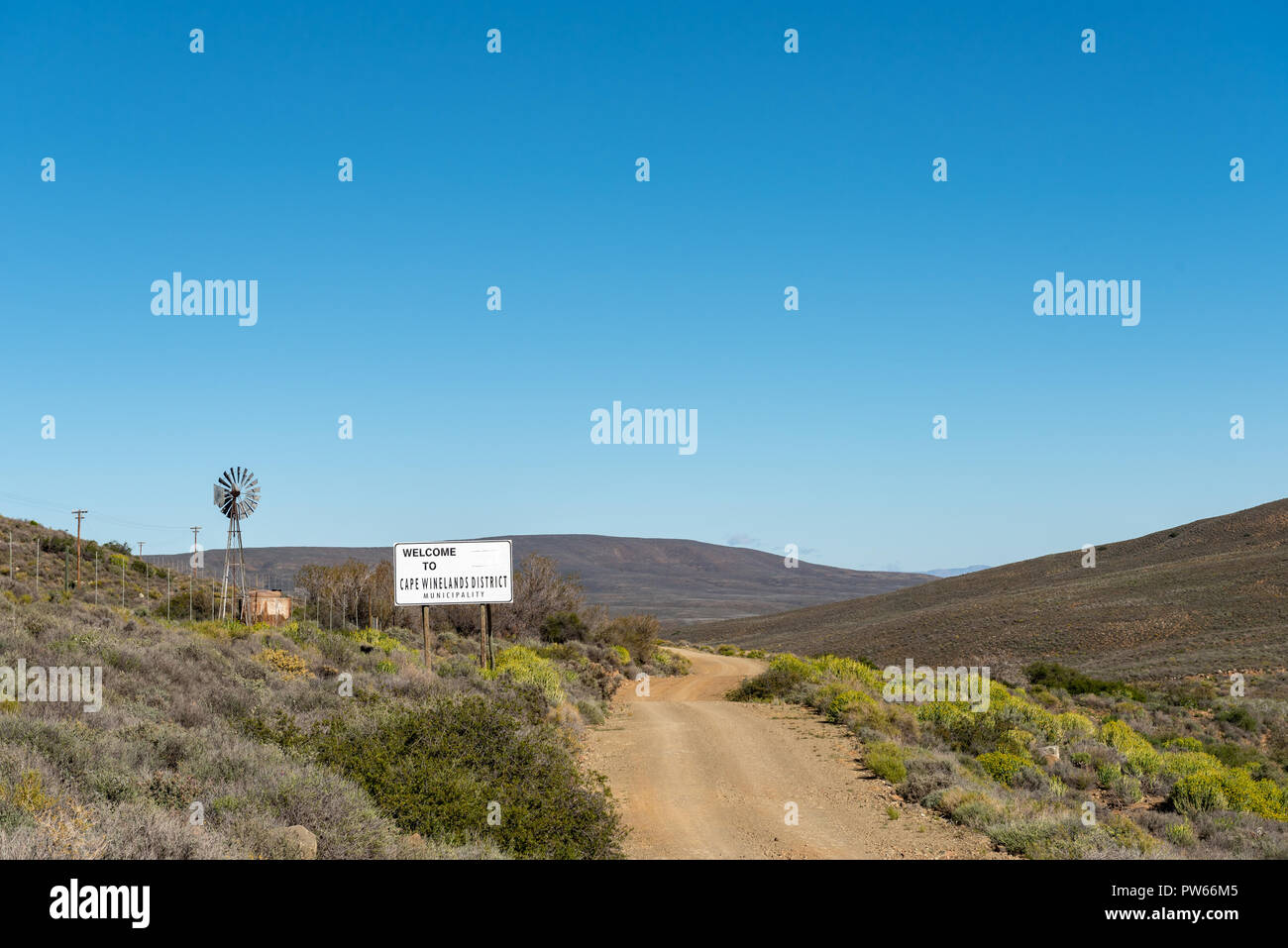A landscape, with sign, windmill and dam, on road R356 to Ceres