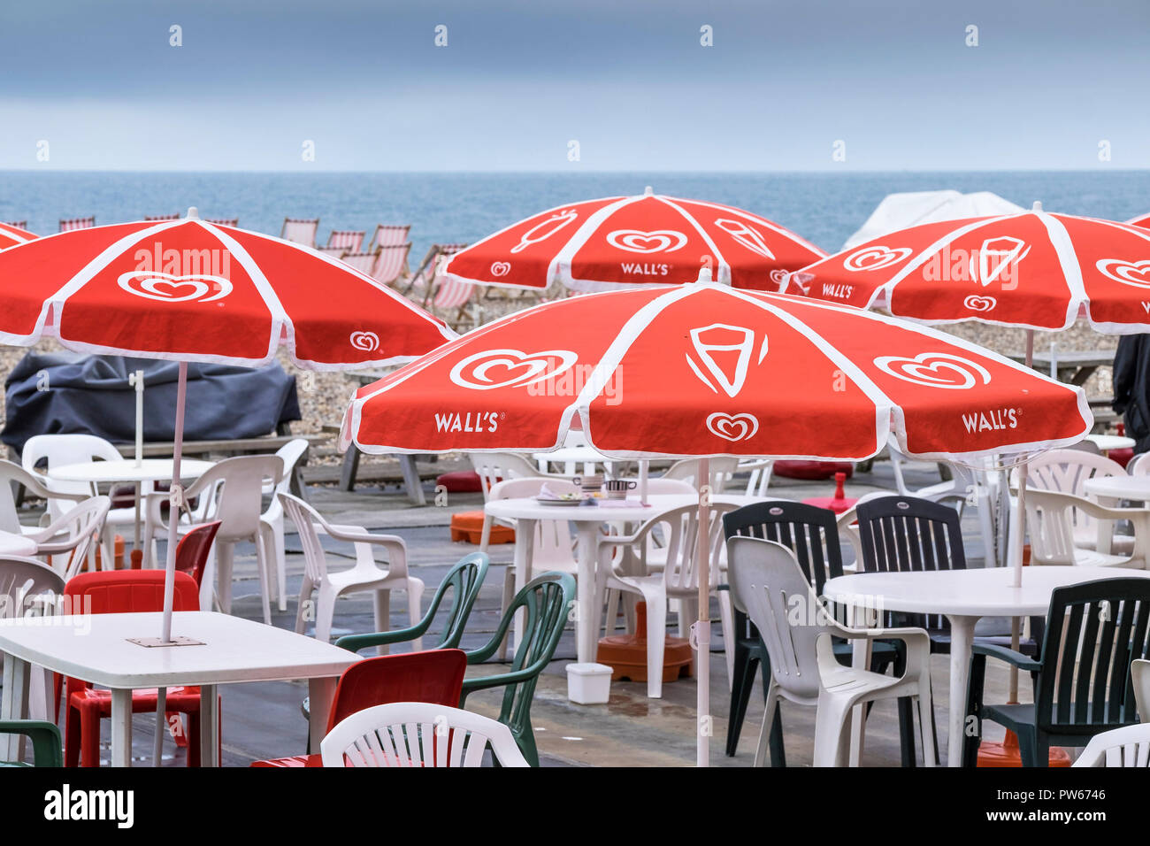 Colourful parasols umbrellas over tables and chairs on Beer Beach in