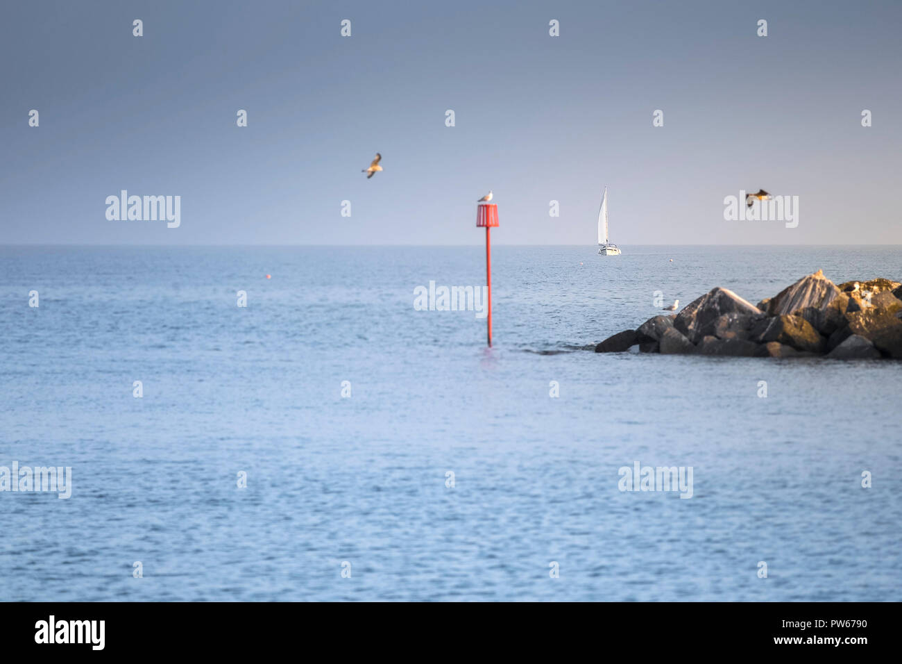 A sail boat in the English Channel on a hazy day Stock Photo Alamy