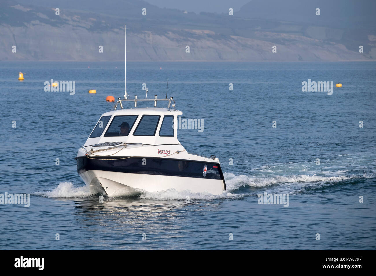 A small motor boat off the coast of Dorset. Stock Photo