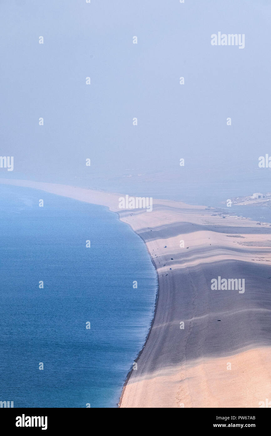 Hazy weather over Chesil Beach in Dorset in the UK. Stock Photo