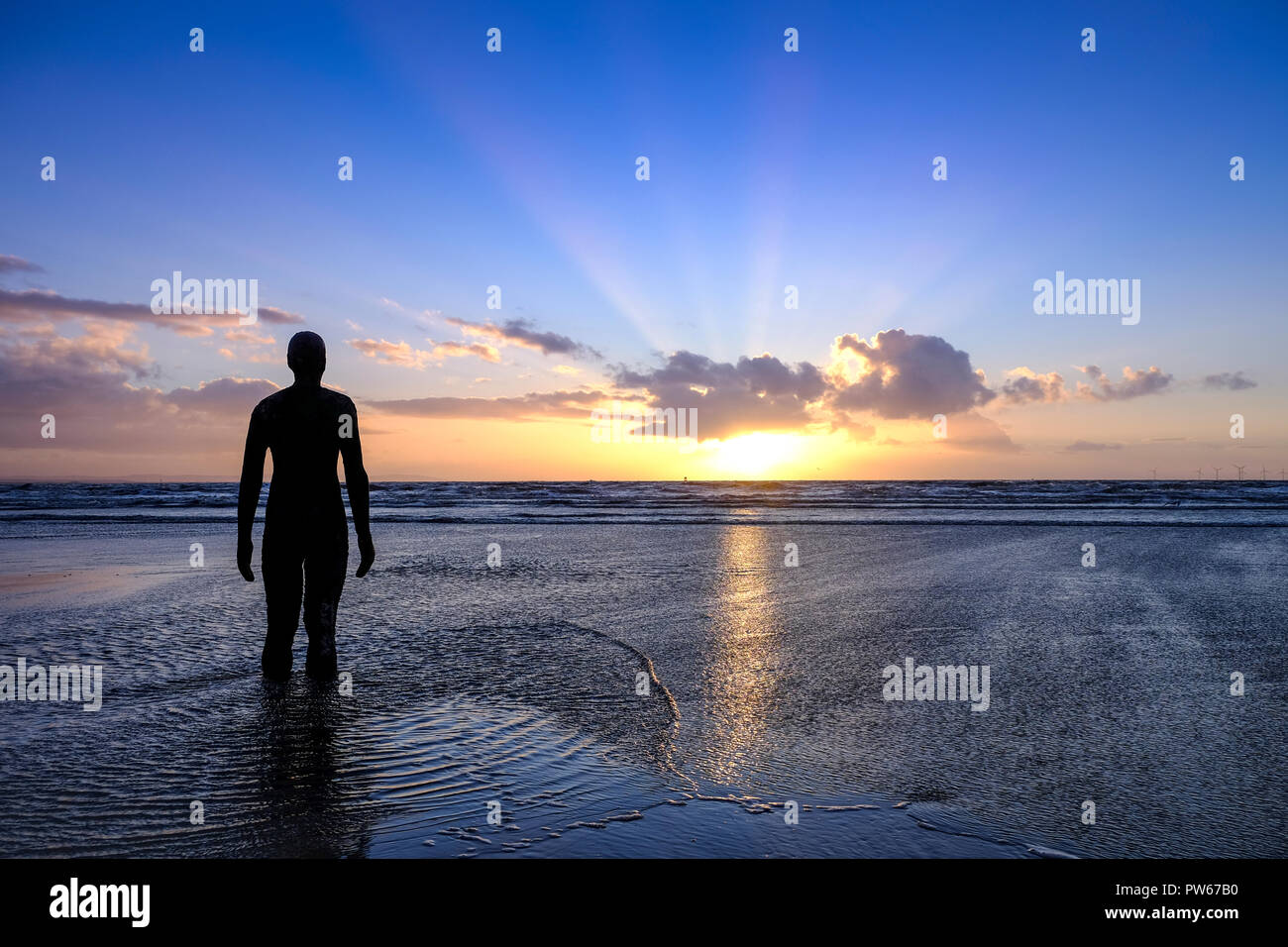 'Another Place' by Antony Gormley Iron Man statues on Crosby Beach Liverpool Merseyside Stock Photo