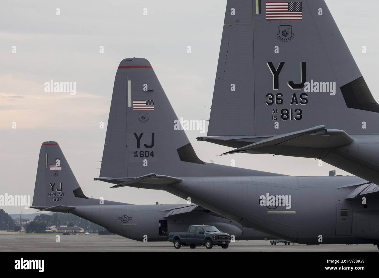 Three C-130J Super Hercules’ sit on the flightline at Yokota Air Base, Japan, Sept. 20, 2017. The C-130J shown in the middle is the fifth to be delivered to Yokoa and the first from Ramstein Air Base, Germany. Crewmembers from the 36th Airlift Squadron flew halfway around the world to deliver this aircraft here. Yokota serves as the primary Western Pacific airlift hub for U.S. Air Force peacetime and contingency operations. Missions included tactical airland, airdrop, aeromedical evacuation, special operations and distinguished visitor airlift. Stock Photo