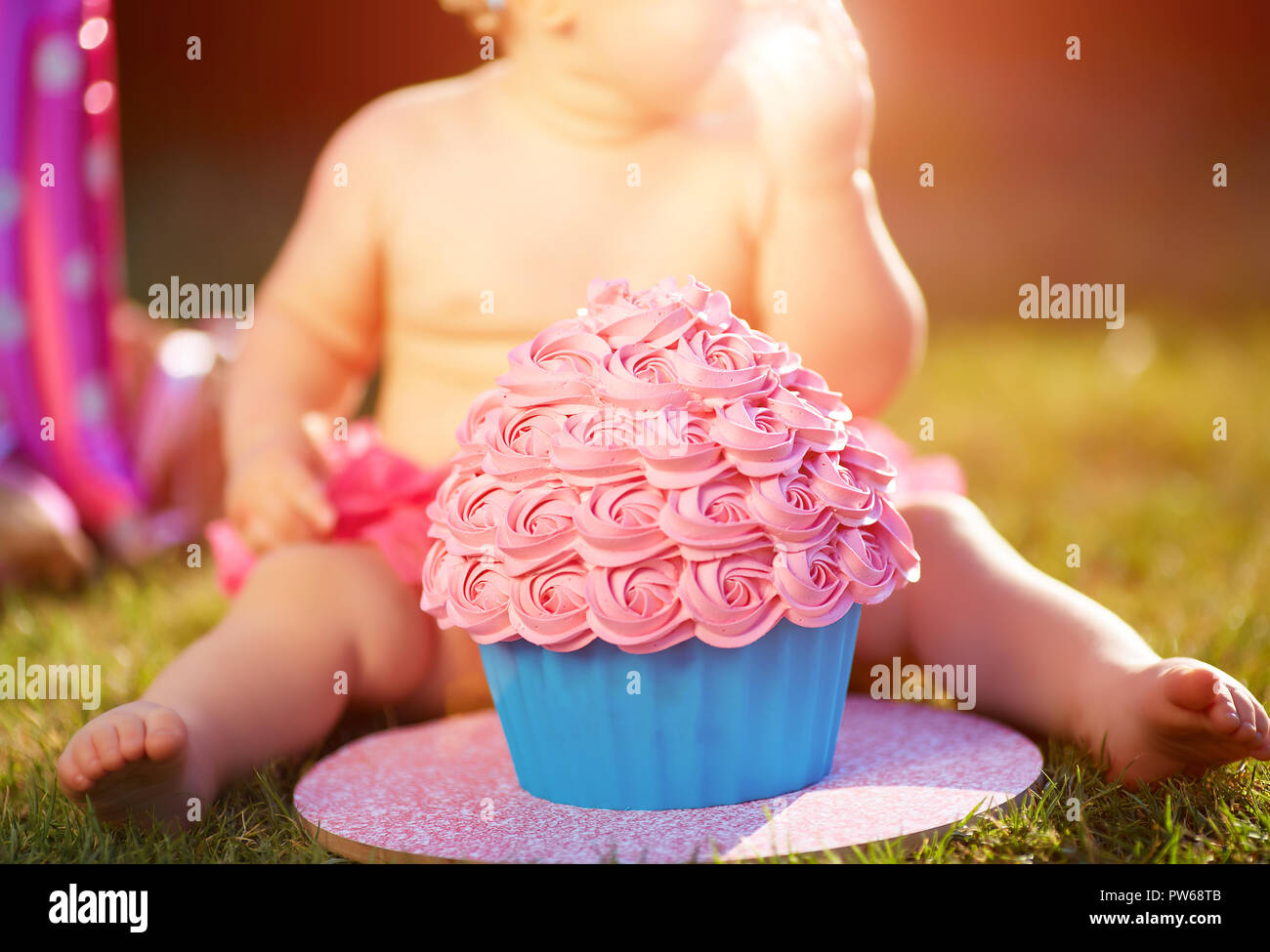 One year old girl eating her first cake Stock Photo