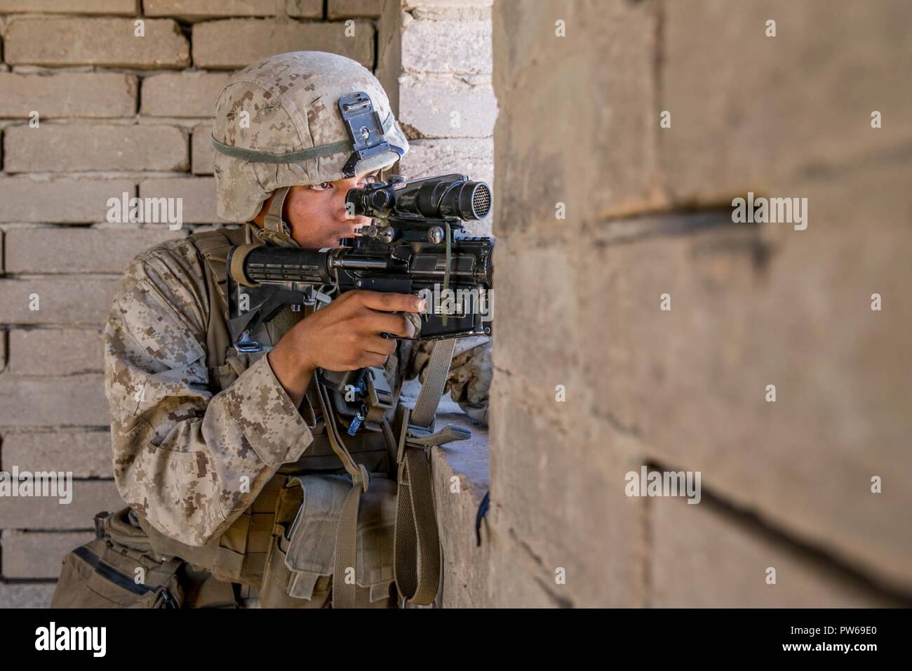 U.S. Marine Corps Lance Cpl. Brian Sanchezangel, an infantry Marine with Kilo Company, 3rd Battalion, 1st Marines, holds security for a rehearsal raid during Weapons and Tactics Instructors Course (WTI) 1-18 at Yuma, Ariz., on Sept. 27, 2017. WTI is a seven week training event hosted by Marine Aviation and Weapons Tactics Squadron One (MAWTS-1) cadre which emphasizes operational integration of the six functions of Marine Corps Aviation in support of a Marine Air Ground Task Force. MAWTS-1 provides standardized advanced tactical training and certification of unit instructor qualifications to su Stock Photo