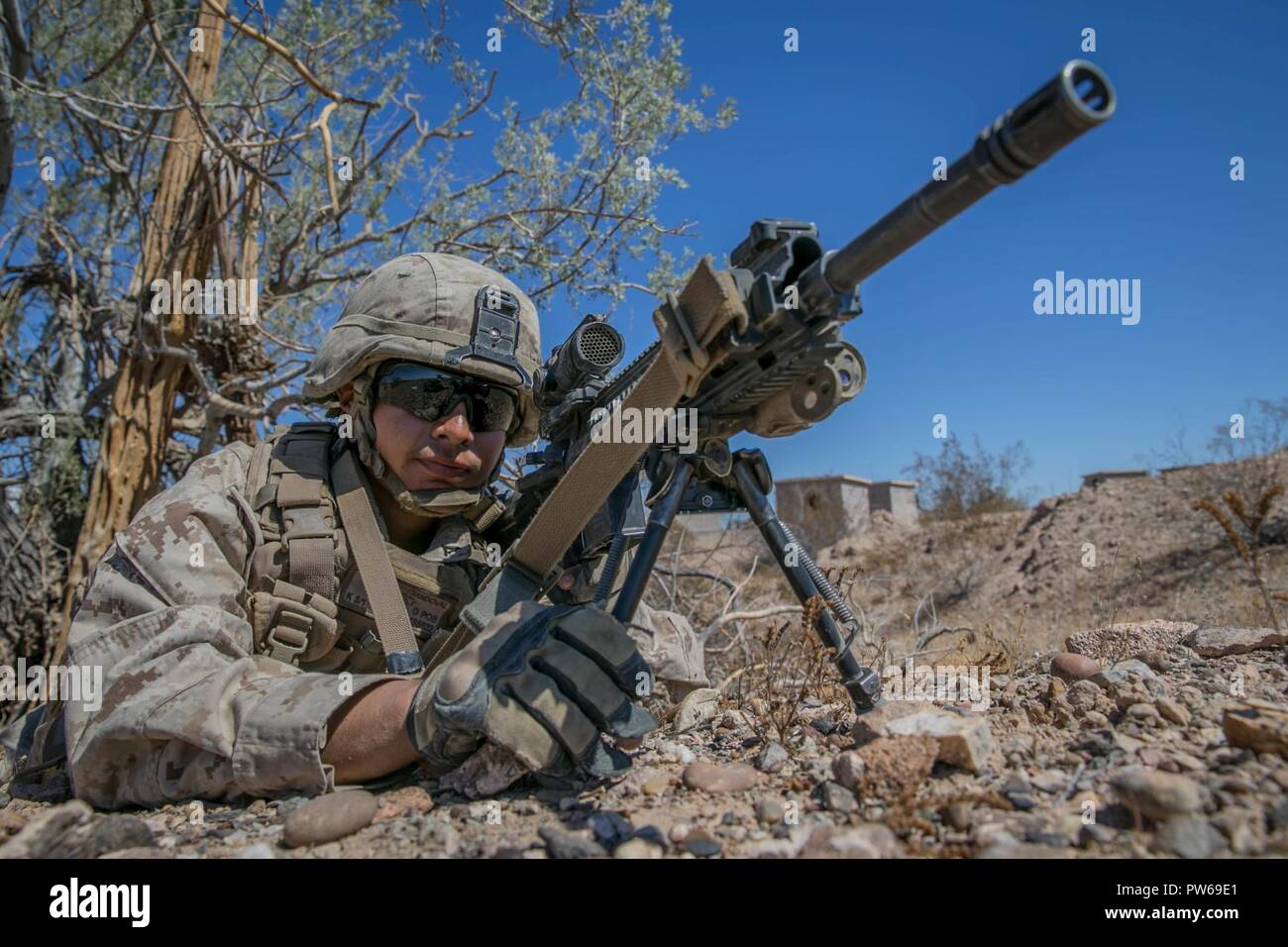 U.S. Marine Corps Lance Cpl. Alfredo Sandoval, an infantry Marine with Kilo Company, 3rd Battalion, 1st Marines, holds security for a rehearsal raid during Weapons and Tactics Instructors Course (WTI) 1-18 at Yuma, Ariz., on Sept. 27, 2017. WTI is a seven week training event hosted by Marine Aviation and Weapons Tactics Squadron One (MAWTS-1) cadre which emphasizes operational integration of the six functions of Marine Corps Aviation in support of a Marine Air Ground Task Force. MAWTS-1 provides standardized advanced tactical training and certification of unit instructor qualifications to supp Stock Photo
