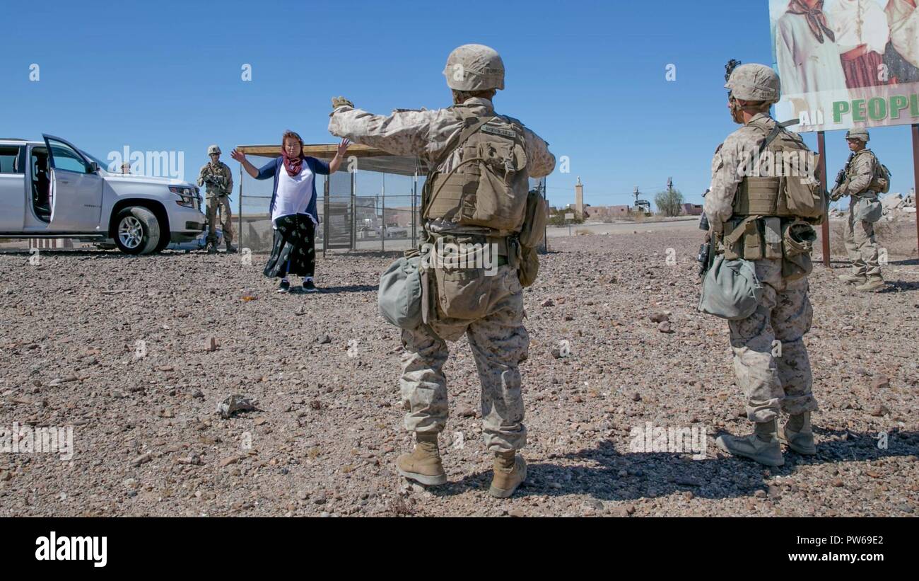 U.S. Marine Corps Lance Cpl. Jose Rodriguez, an infantry Marine with Kilo Company, 3rd Battalion, 1st Marines, calls commands to a role player during Weapons and Tactics Instructors Course (WTI) 1-18 at Yuma, Ariz., on Sept. 27, 2017. WTI is a seven week training event hosted by Marine Aviation and Weapons Tactics Squadron One (MAWTS-1) cadre which emphasizes operational integration of the six functions of Marine Corps Aviation in support of a Marine Air Ground Task Force. MAWTS-1 provides standardized advanced tactical training and certification of unit instructor qualifications to support Ma Stock Photo