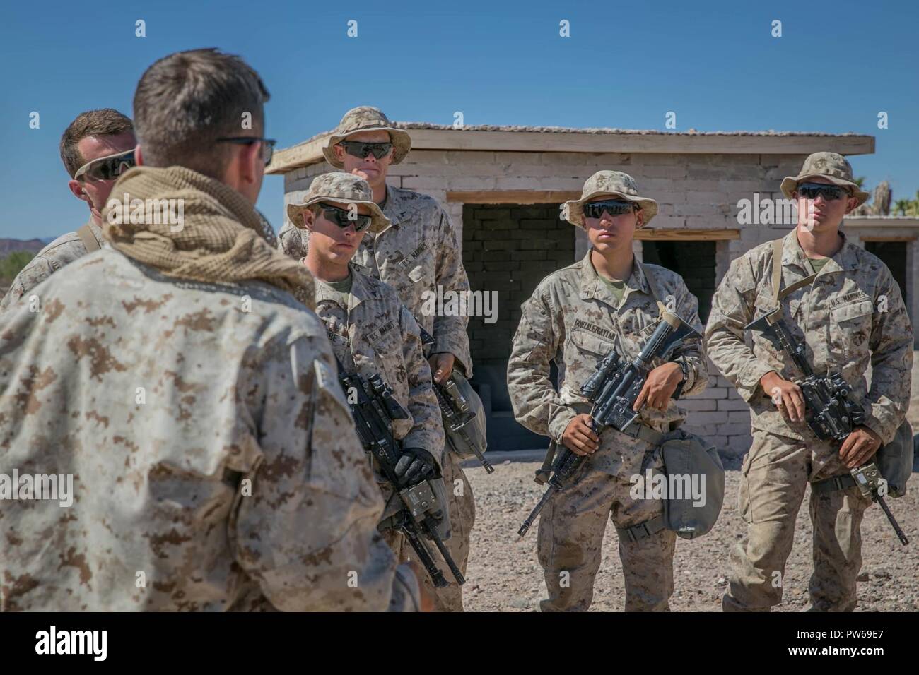 U.S. Marine Corps Lance Cpl. Garrett Krause, a motorman with Kilo Company, 3rd Battalion, 1st Marines, gives a class on conducting a body search during Weapons and Tactics Instructors Course (WTI) 1-18 at Yuma, Ariz., on Sept. 27, 2017. WTI is a seven week training event hosted by Marine Aviation and Weapons Tactics Squadron One (MAWTS-1) cadre which emphasizes operational integration of the six functions of Marine Corps Aviation in support of a Marine Air Ground Task Force. MAWTS-1 provides standardized advanced tactical training and certification of unit instructor qualifications to support  Stock Photo