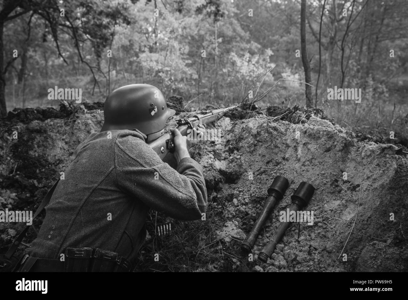 Unidentified Re-enactor Dressed As German Wehrmacht Infantry Soldier In  World War II Hidden Sitting With Rifle Weapon In An Ambush In Trench In  Autumn Stock Photo - Alamy