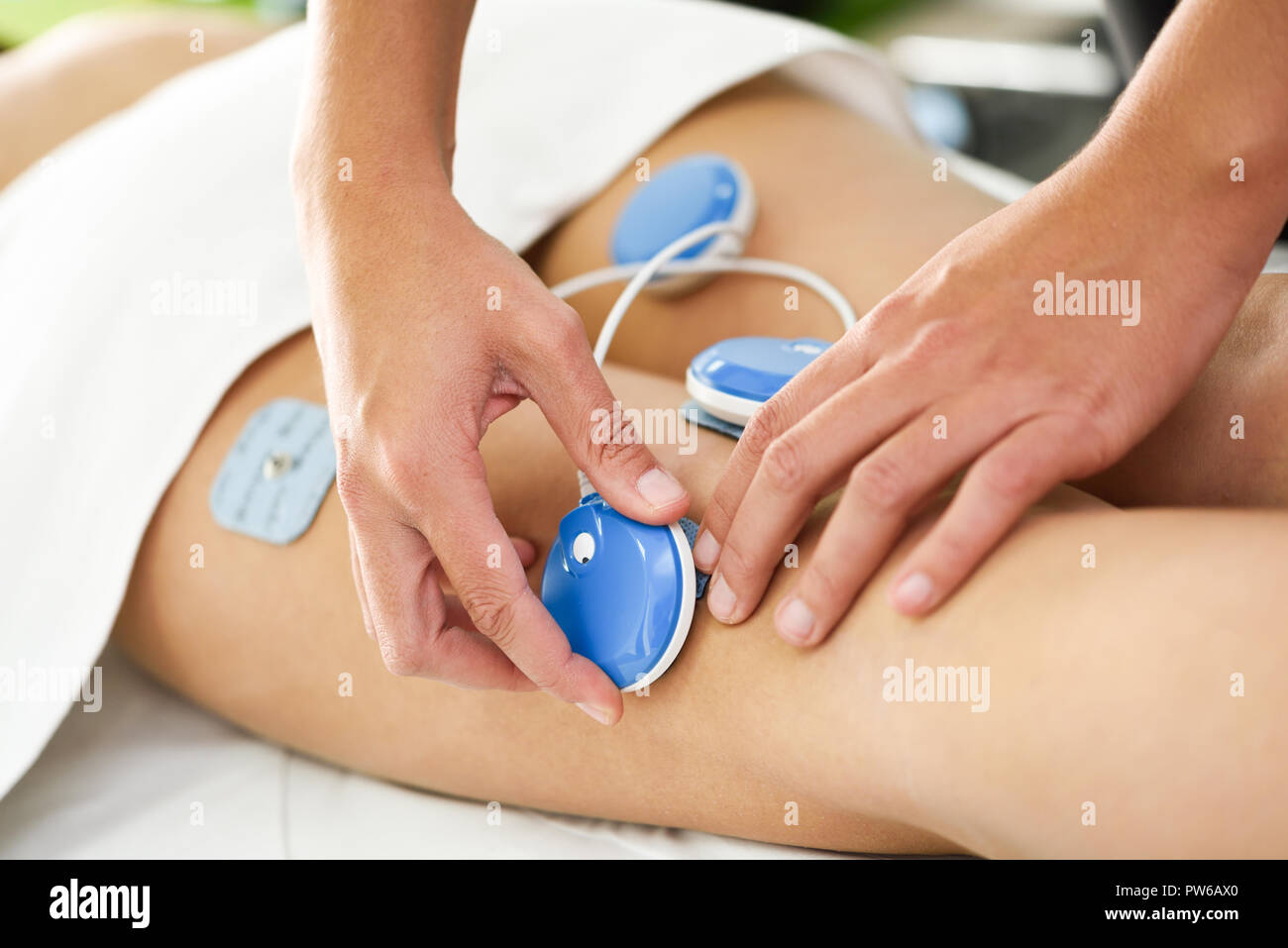 https://c8.alamy.com/comp/PW6AX0/physiotherapist-applying-electro-stimulation-in-physical-therapy-to-a-young-woman-medical-check-at-the-leg-in-a-physiotherapy-center-PW6AX0.jpg