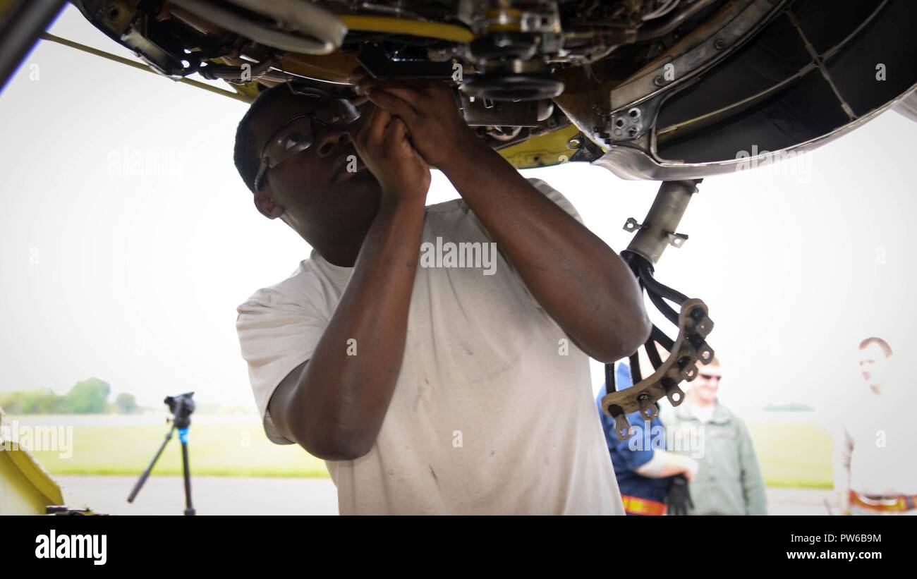 Senior Airman Denzel Henderson, 96th Aircraft Maintenance Unit electrical and environmental systems technician, changes a drive generator on a B-52 Stratofortress at Fairford Royal Air Force Base, U.K., Sept. 20, 2017. Drive generators must be changed if they overheat during a flight. The change takes around six hours to complete and will ensure continued power for B-52 electrical systems. Stock Photo