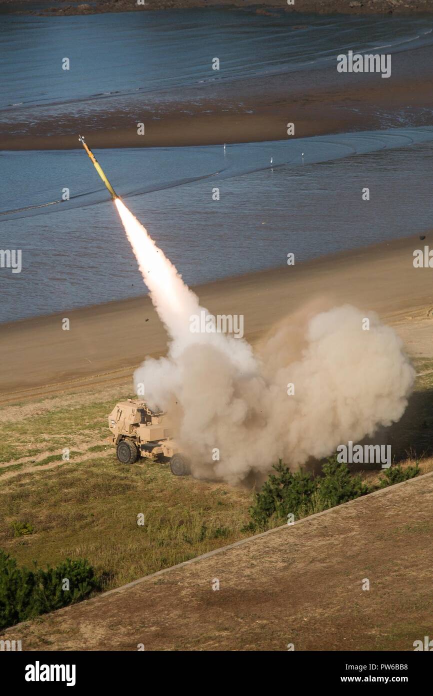 U.S. Soldiers assigned to the 18th Field Artillery Brigade, Fort Bragg, NC launch rockets from an M142 High Mobility Artillery Rocket System (HIMARS), at Daecheon, South Korea, Sept. 21, 2017. The U.S. Army conducted this live fire training, providing South Korean and U.S. forces the ability to launch rockets from mobile locations and strike targets with minimal notice. Stock Photo