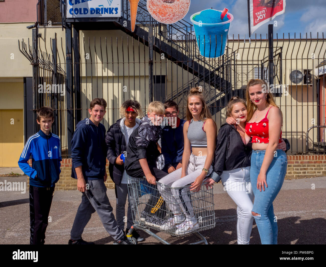 Teenagers with a shopping trolley in the town of Sheerness on a Saturday afternoon. Stock Photo