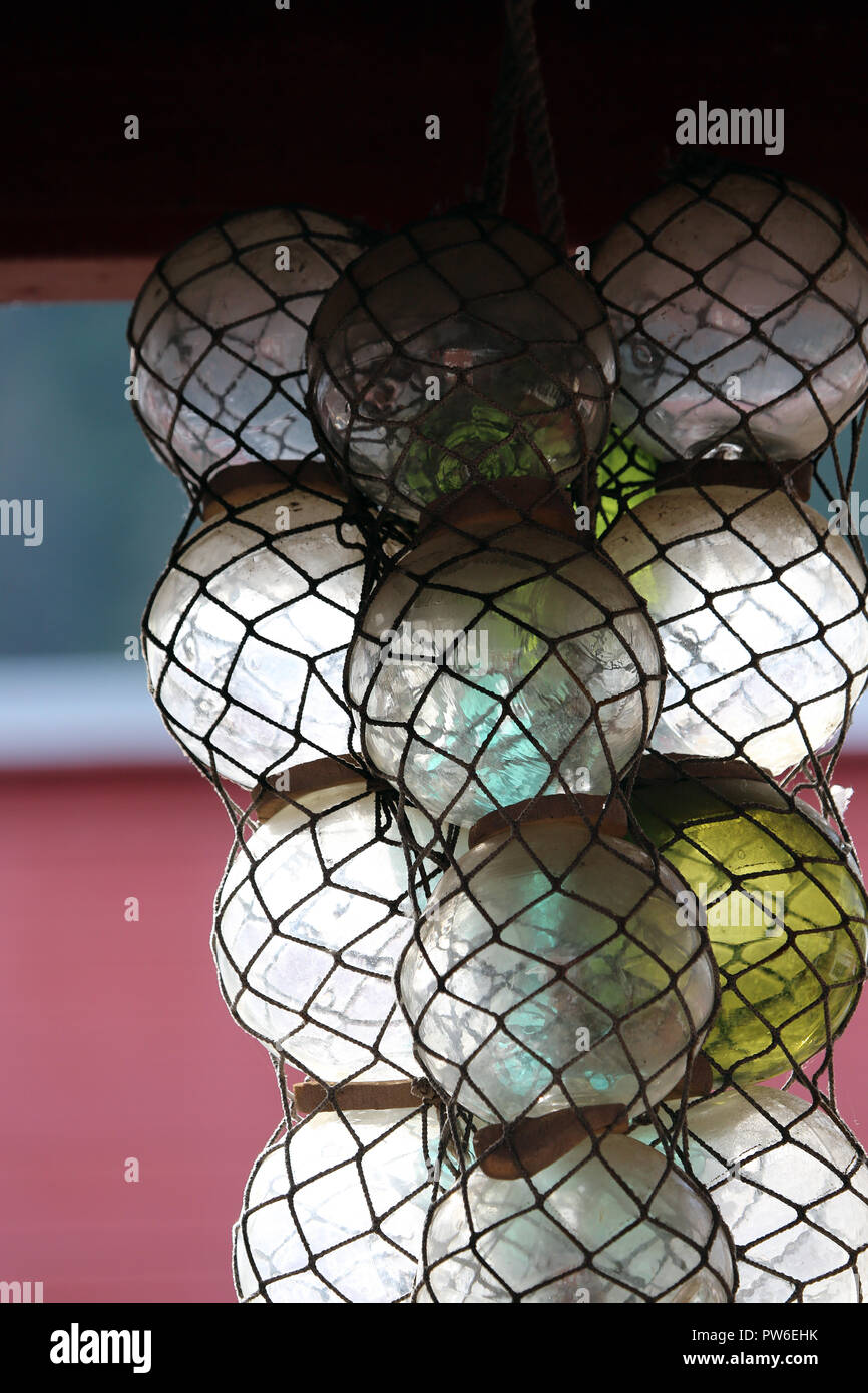 glass fish floats in fish net Stock Photo Alamy