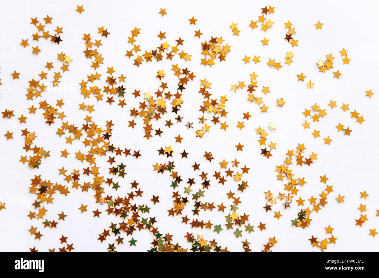 Festive golden stars of confetti on a white background Stock Photo - Alamy