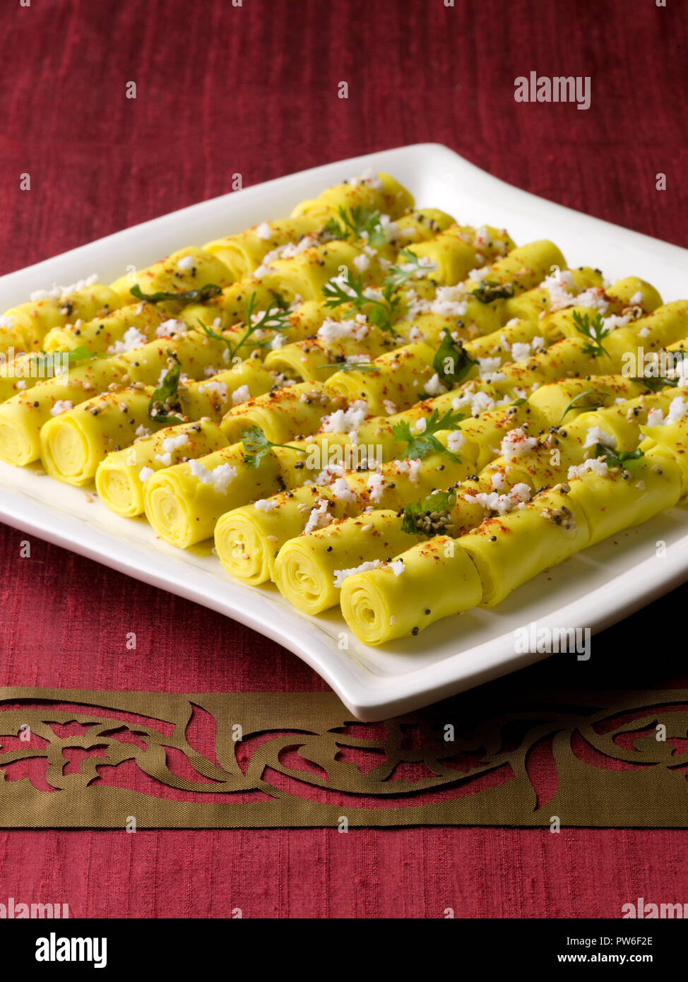 KHANDVI GARNISHED WITH CORIANDER / A STEAMED ROLL MADE FROM GRAM FLOUR Stock Photo