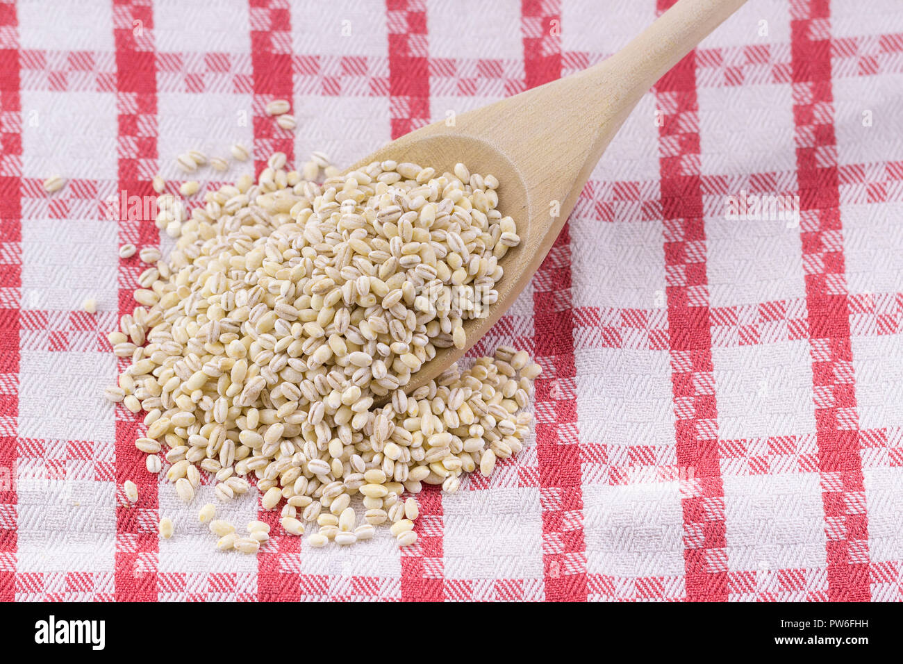 barley bean from wooden spoon Stock Photo Alamy