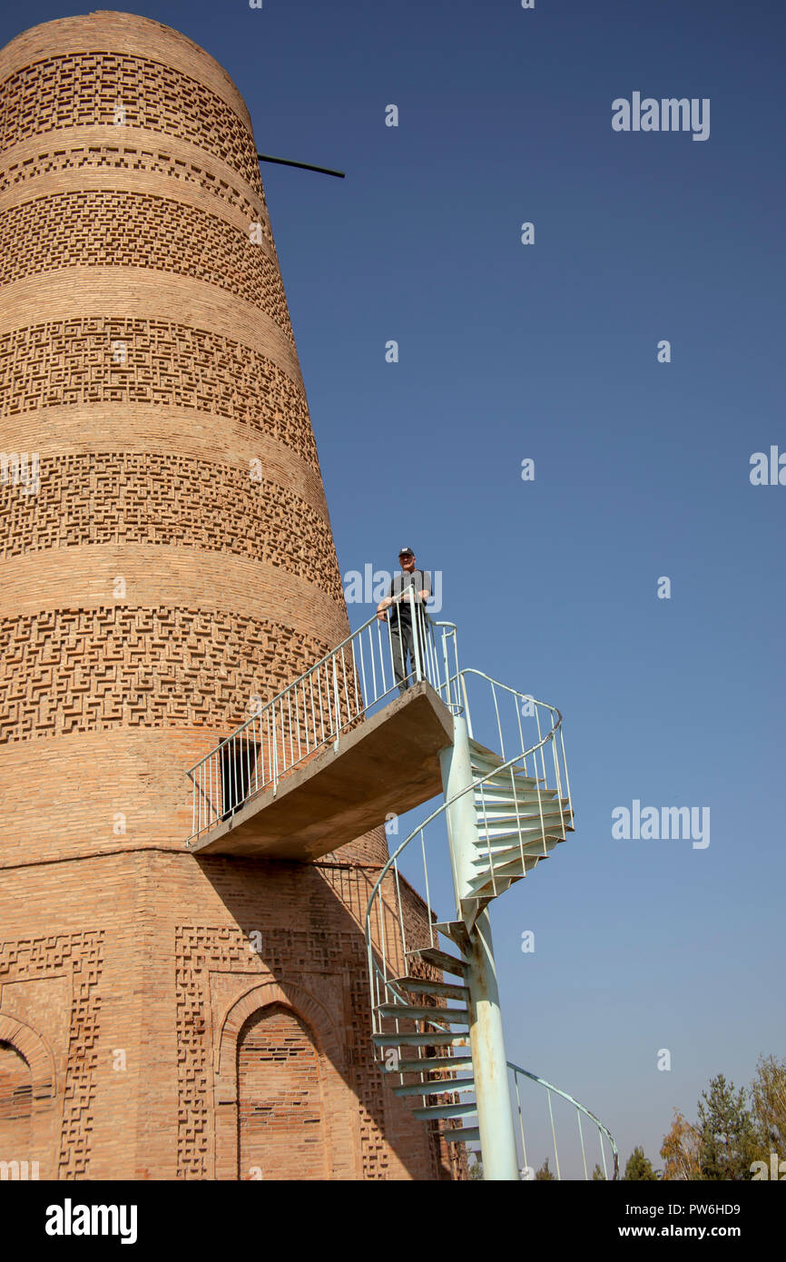 Tourist standing on outside stairs of Burana Tower, Balasagun, Kyrgyzstan. Stock Photo