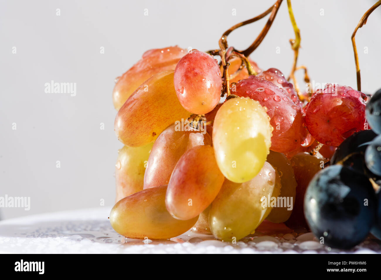 Beautiful grape with wated drops at isolated background Stock Photo