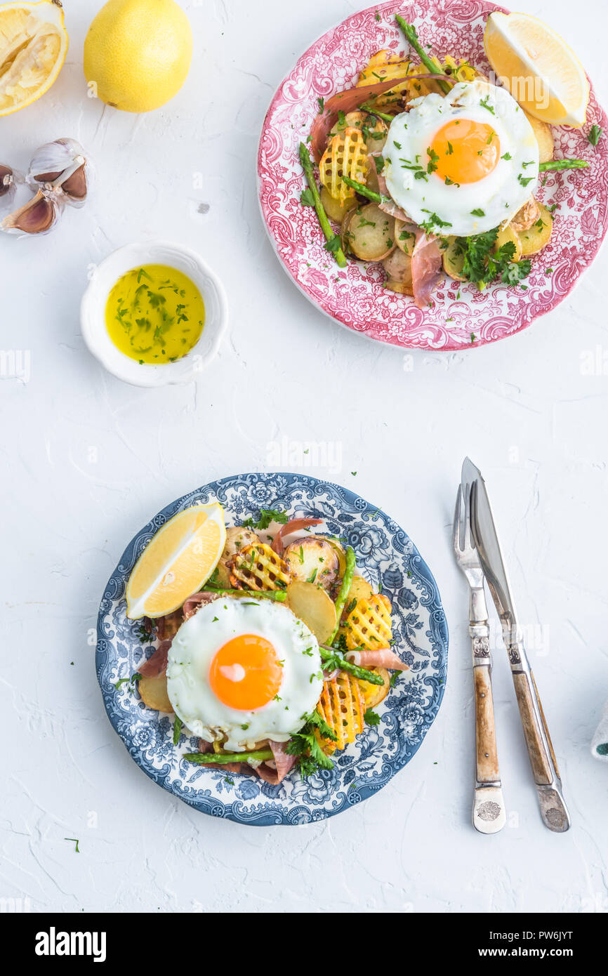 Sunny side egg, potato and jamon ham, Spain breakfast huevos rotos, top