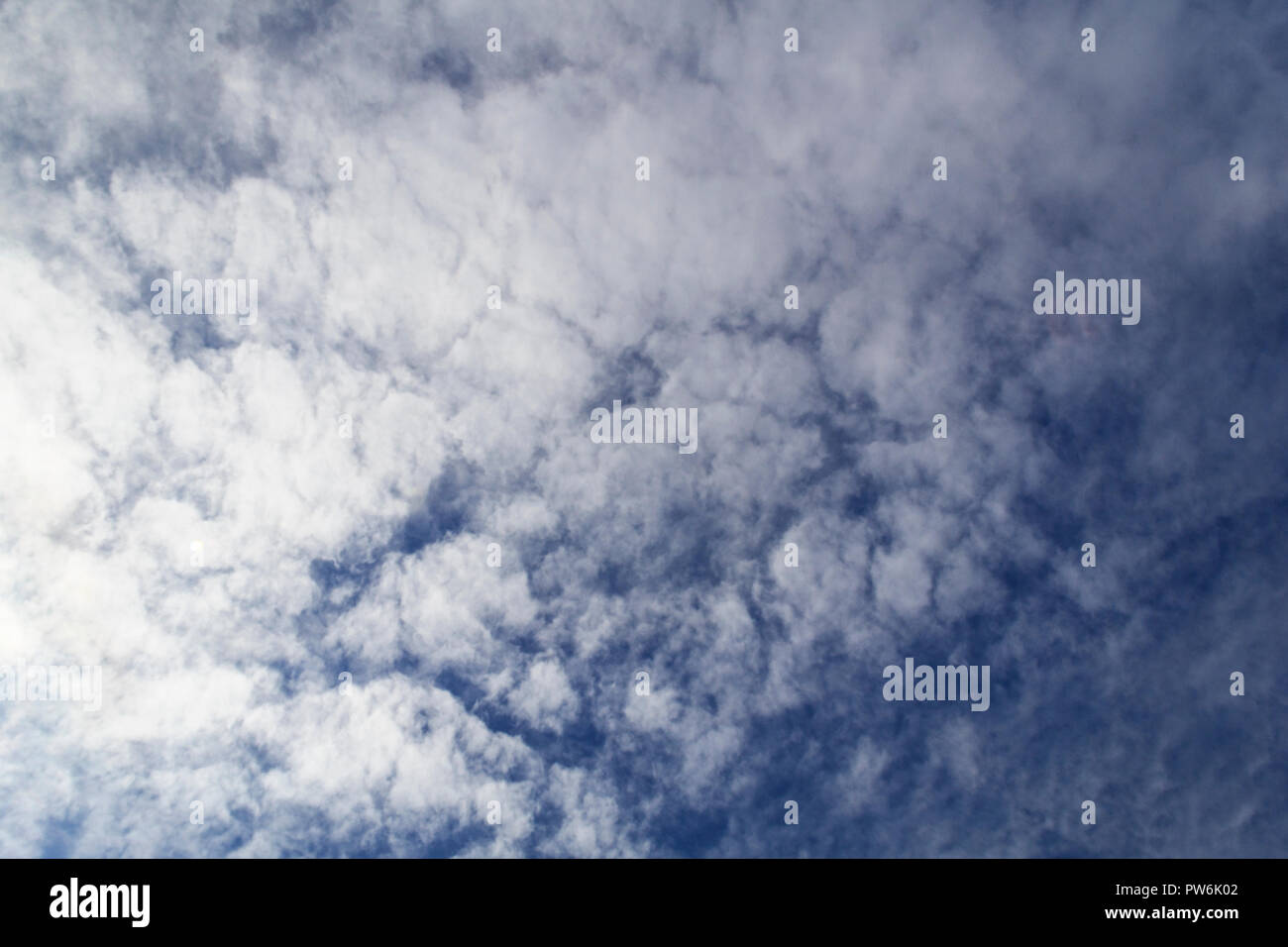 Formation of cirrus clouds against a darkening sky Stock Photo