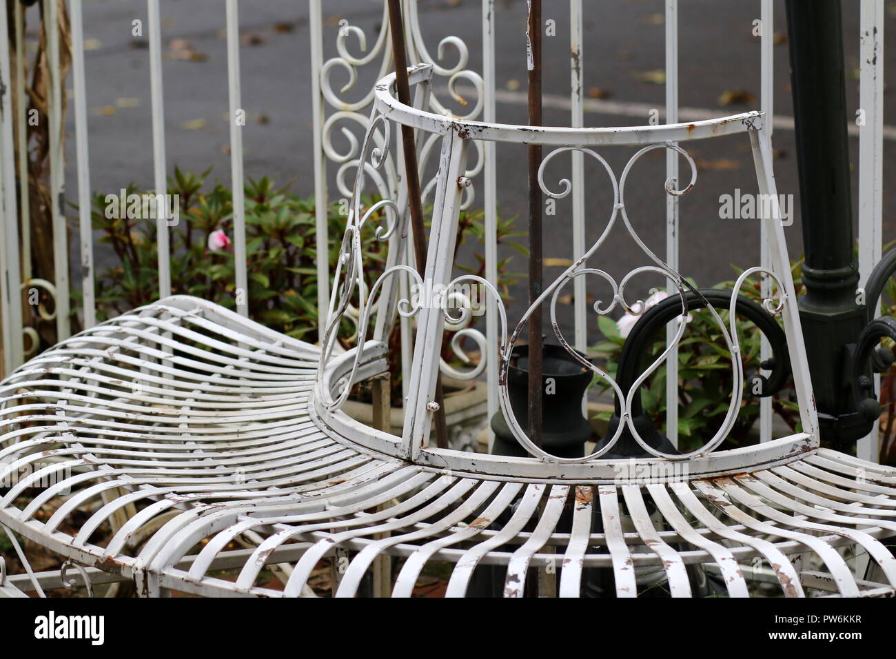 The white wrap around metal chair is an old style. Stock Photo