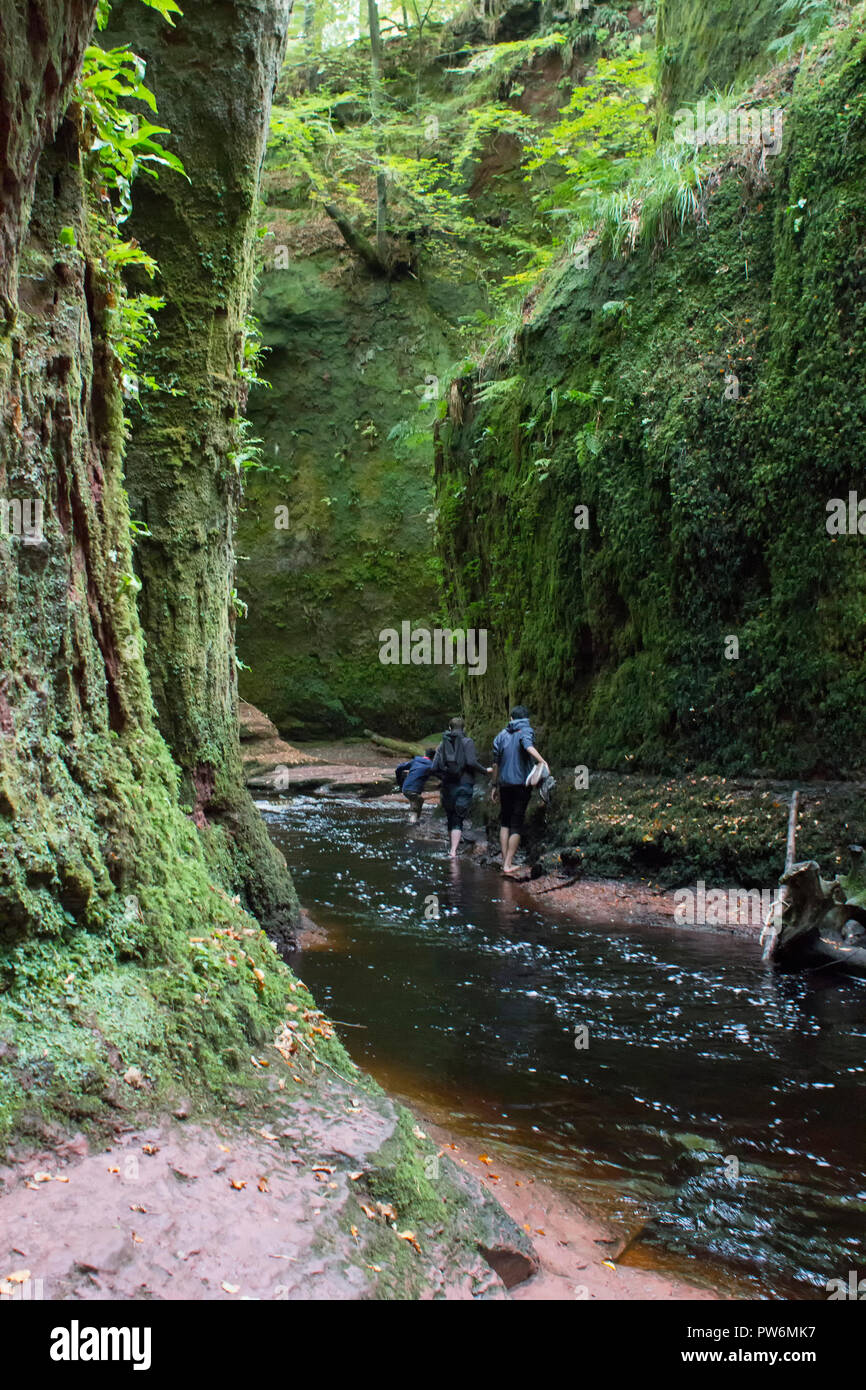 Climbers climing through the Devils Pulpit gorge in the Trossachs of Scotland. Stock Photo