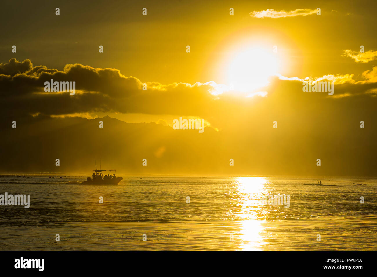 Sihouette of a little boat at sunset, Papeete, Tahiti Stock Photo