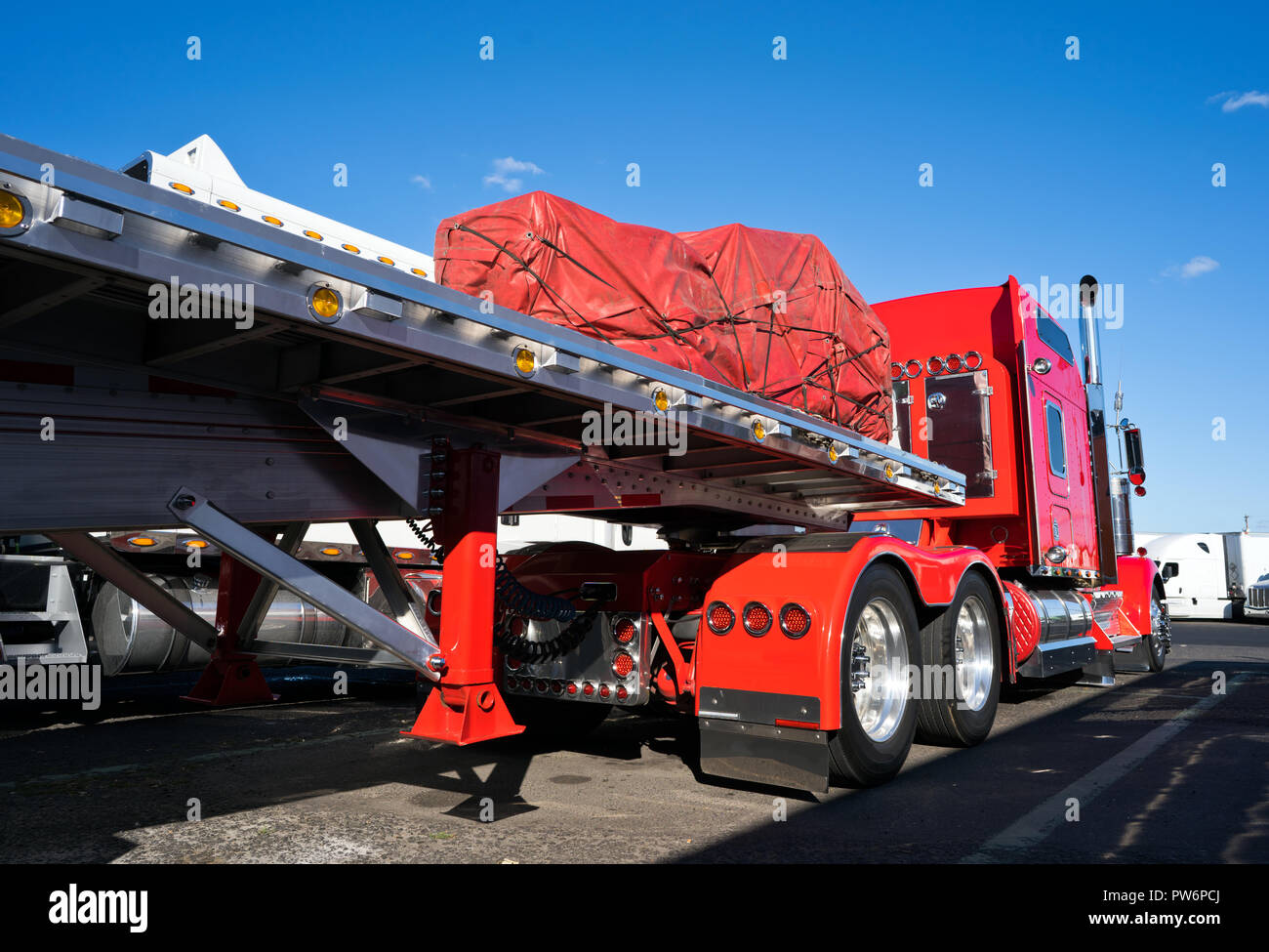 Bright shiny red classic American fancy big rig semi truck