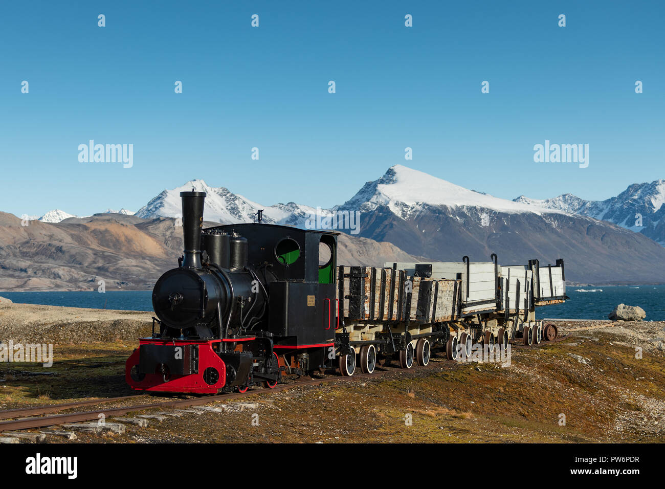 Historic mine train in front of the Kongsfjorden, Ny-Alesund, Spitsbergen, Svalbard Islands, Svalbard and Jan Mayen, Norway Stock Photo
