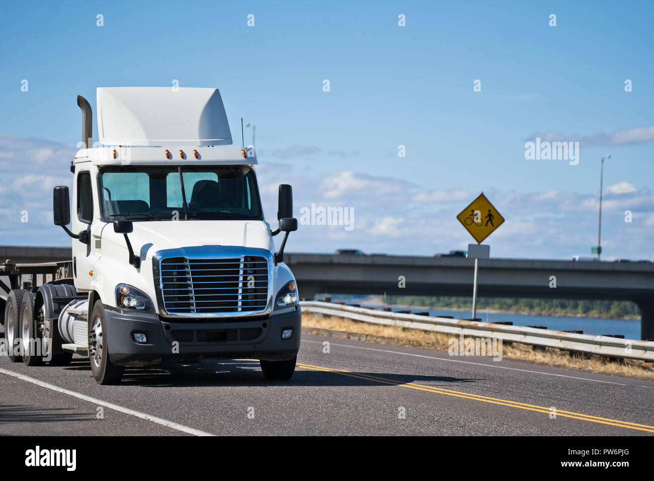White powerful big rig day cab with roof spoiler local hauler semi