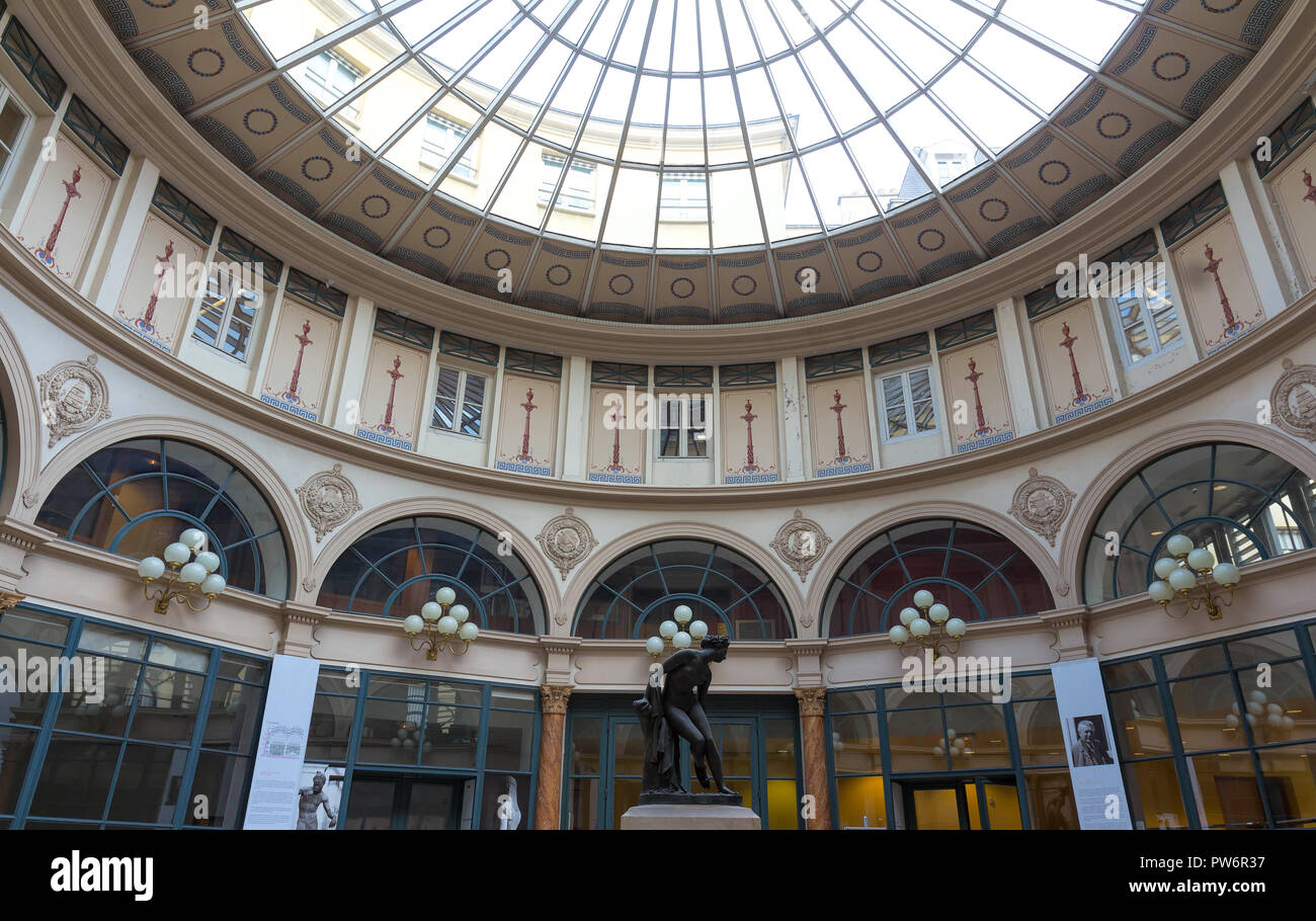 Built in 1823, Galerie Colbert is covered arcade belongs to the Biblioth que Nationale. It is listed as a historical monument often used for cinema . Stock Photo