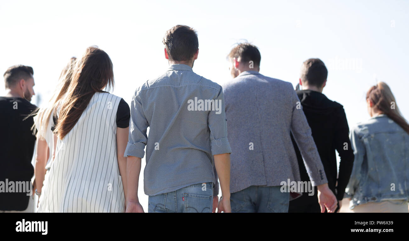 rear view . group of friends showing standing together Stock Photo - Alamy