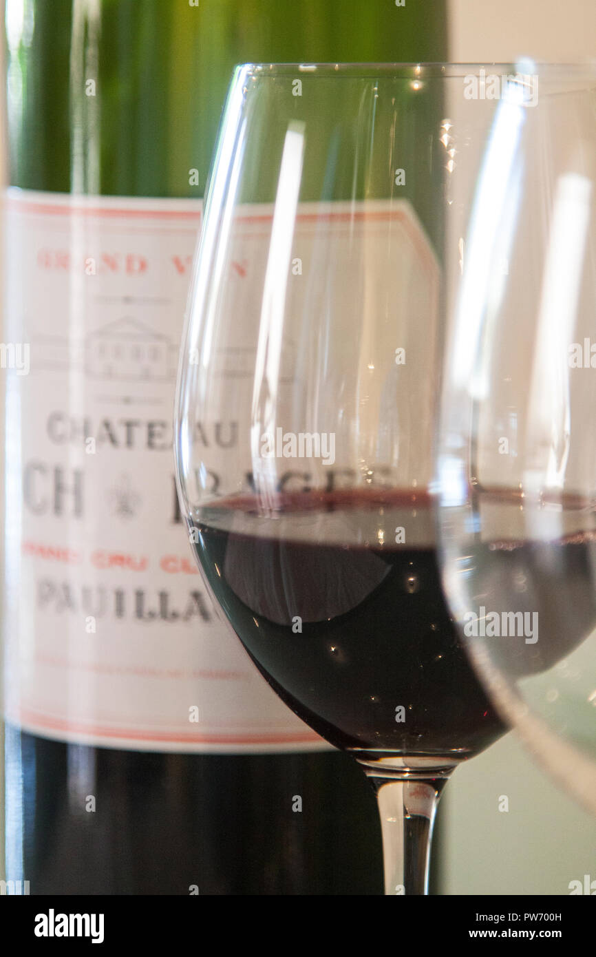 Pauillac Bordeaux red wine in a glass, in front of a bottle Stock Photo