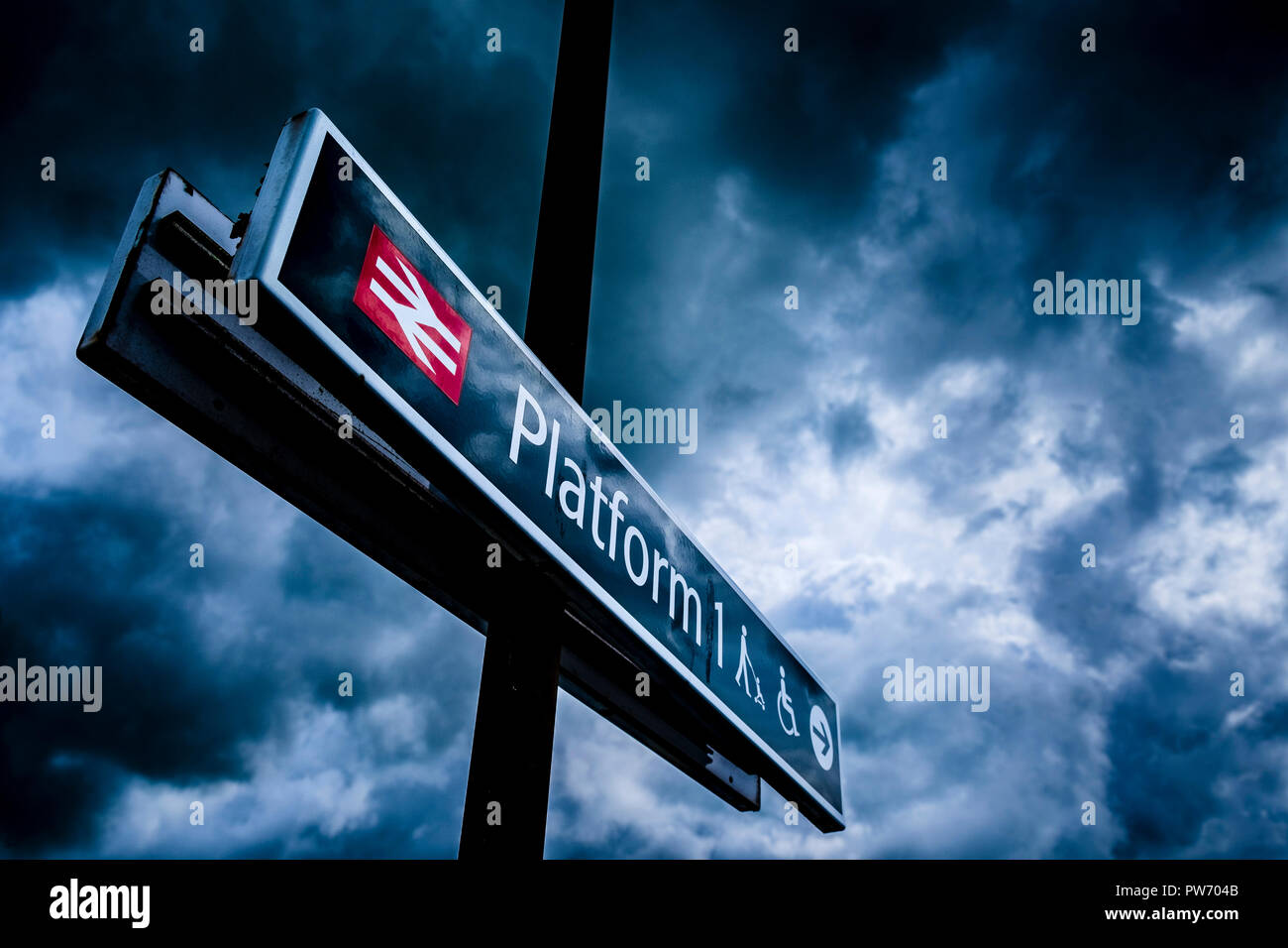 A sign pointing to platform one at a British railway station Stock Photo
