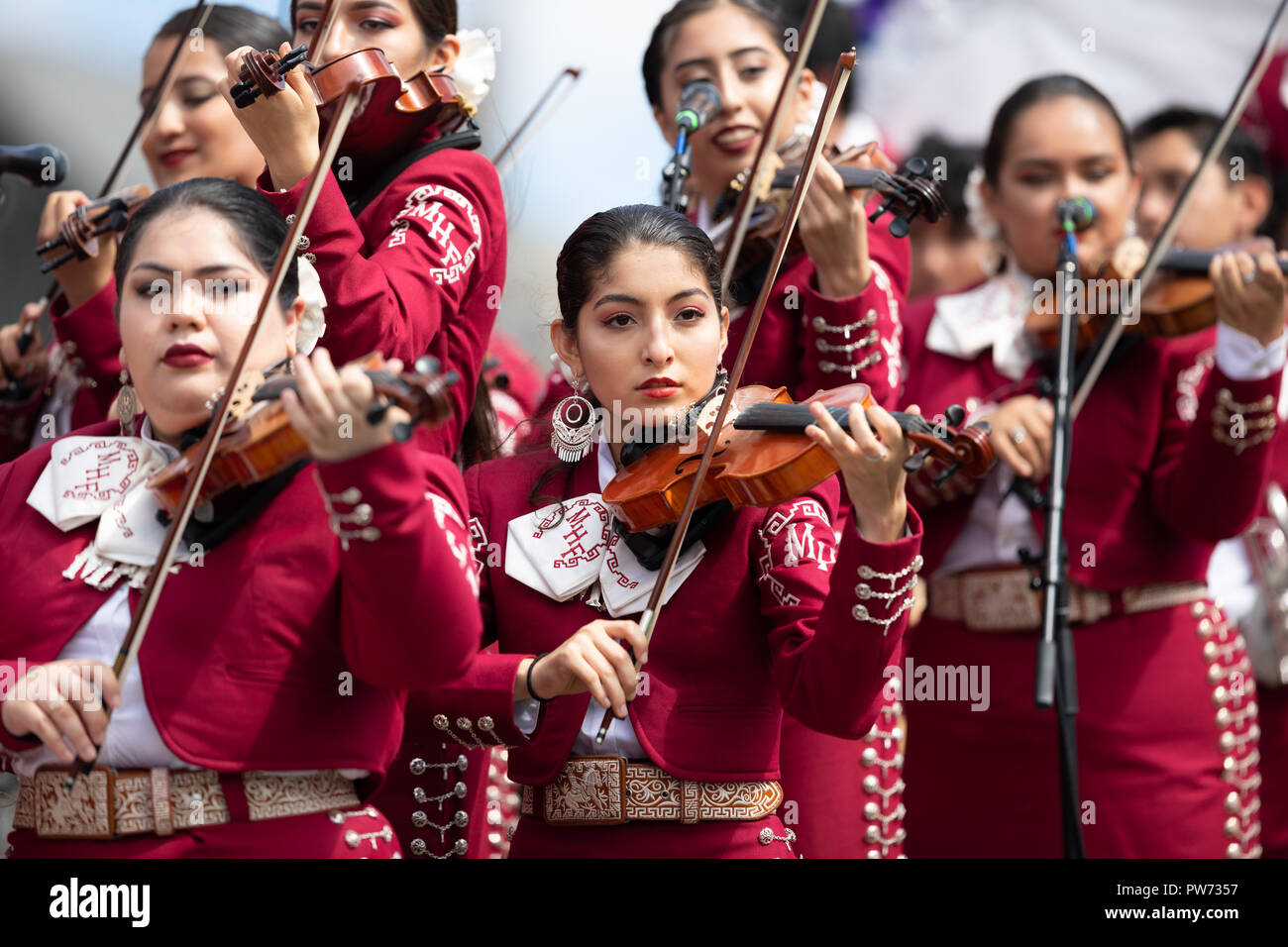 Chicago, Illinois , USA - September 9, 2018 The 26th Street Mexican Independence Parade, Mexican women wearing traditional mariachi clothing playing t Stock Photo