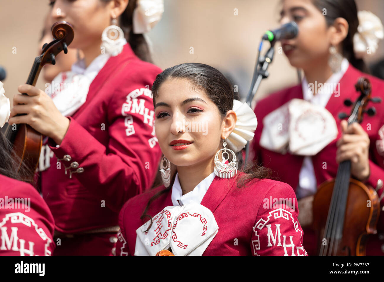 Chicago, Illinois , USA - September 9, 2018 The 26th Street Mexican Independence Parade, Mexican women wearing traditional mariachi clothing playing t Stock Photo