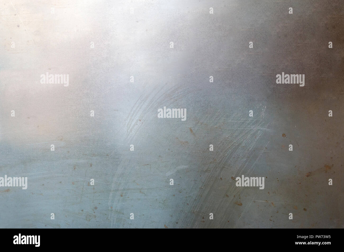 Silver metal alloy steel surface with markings and scratches backdrop