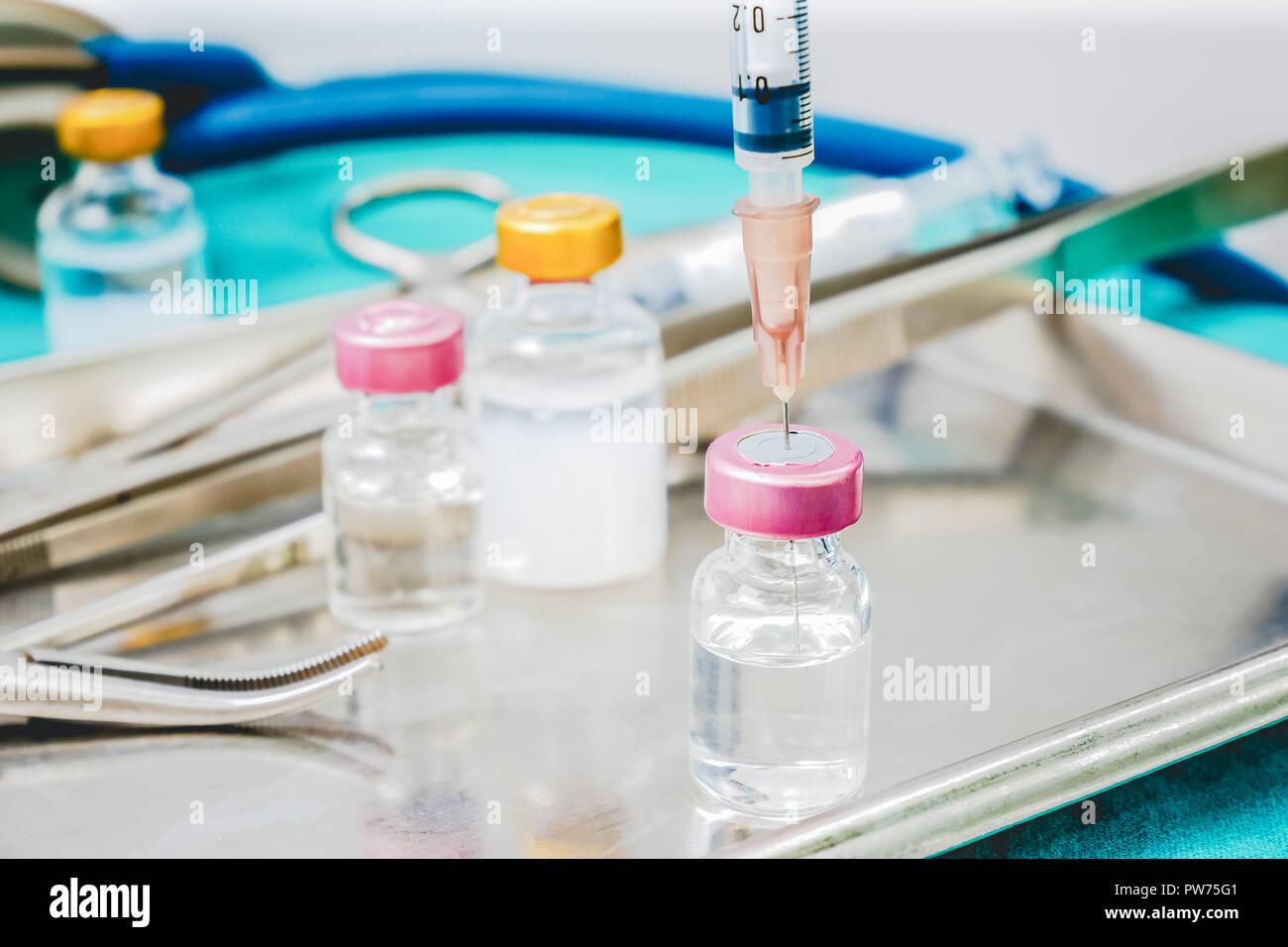 Syringe and medicine vials on doctor work park table close up for healthcare diagnosis concept background Stock Photo