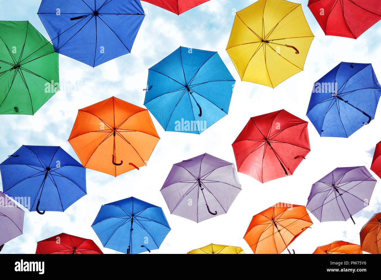 colorful umbrellas hanging against the sky. Stock Photo