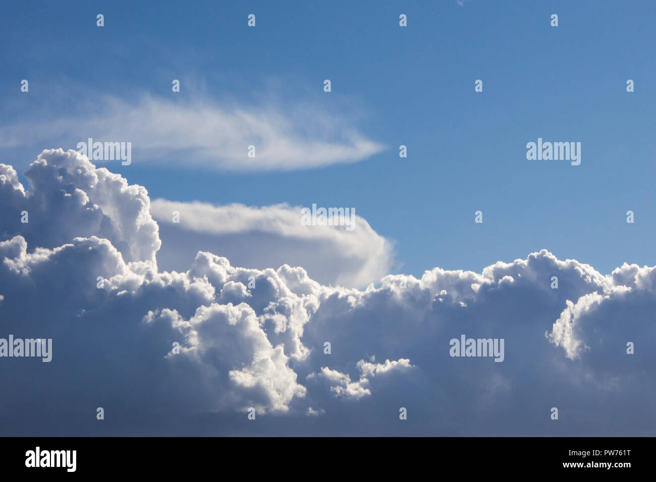 Cumulus clouds on blue sky background highlighted with sun Stock Photo ...