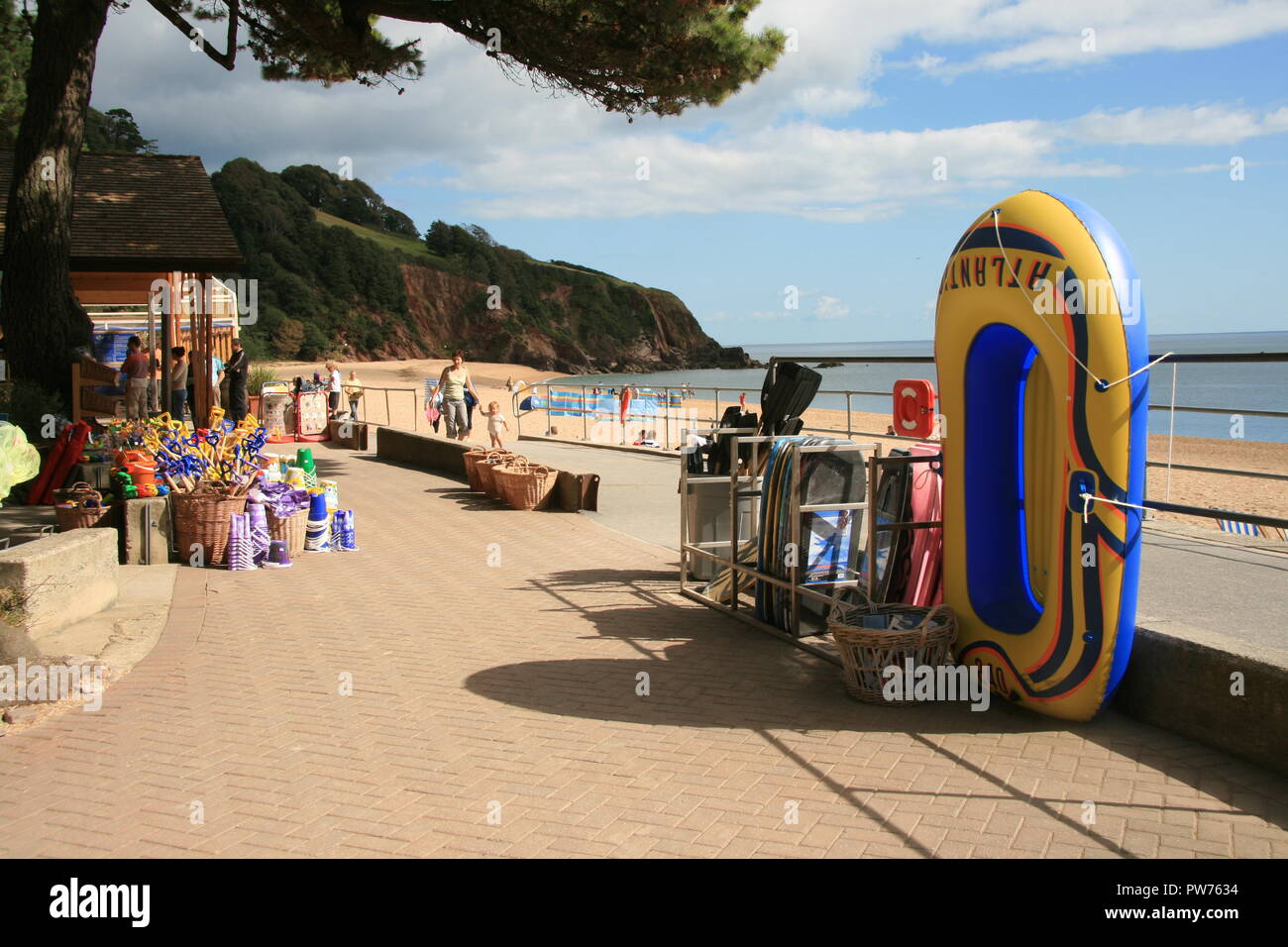 Beach toys buckets spades and inflatable boats for sale at the seaside