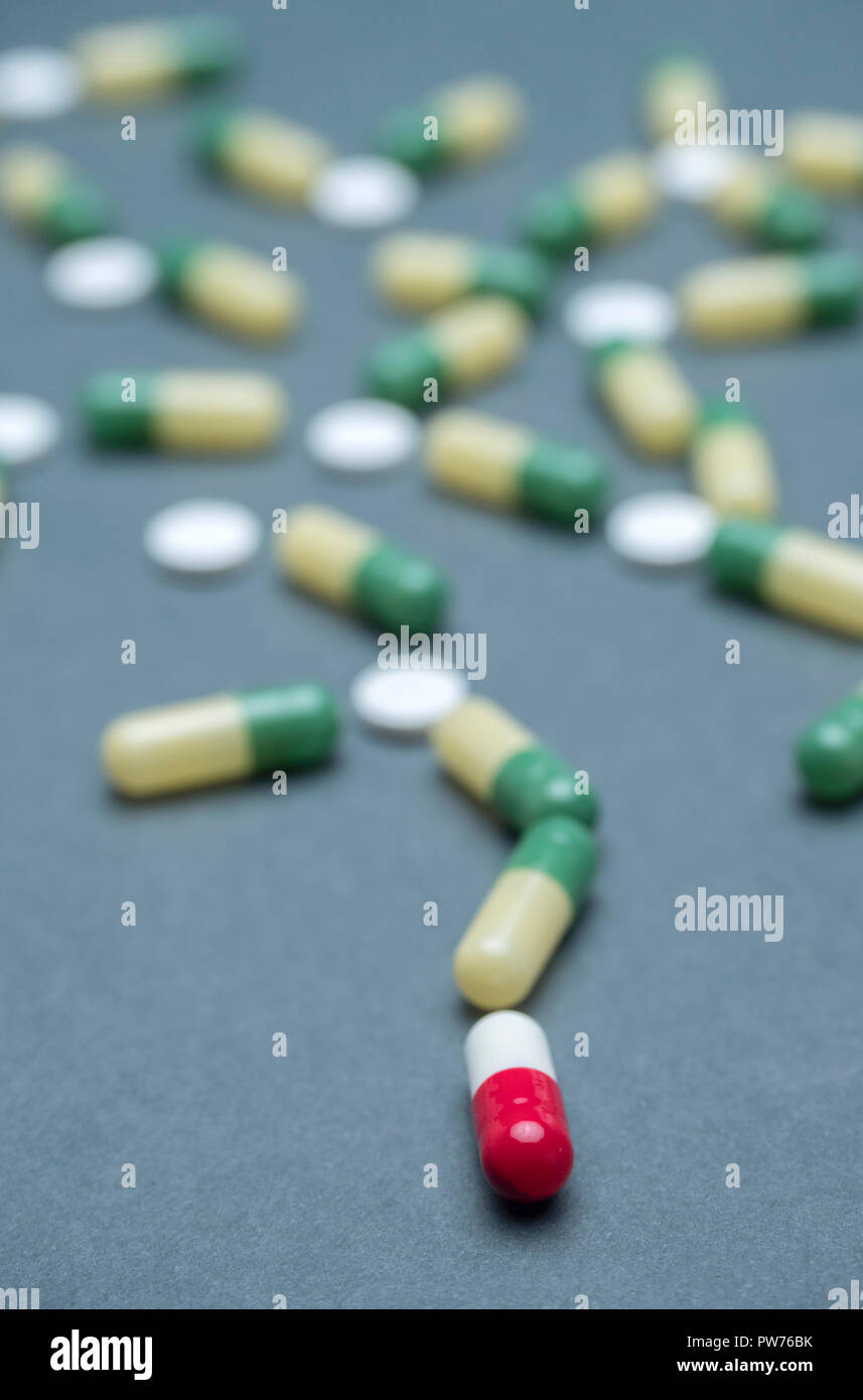 Training of random capsules white and green isolated on a blue background, conceptual image, conceptual image Stock Photo