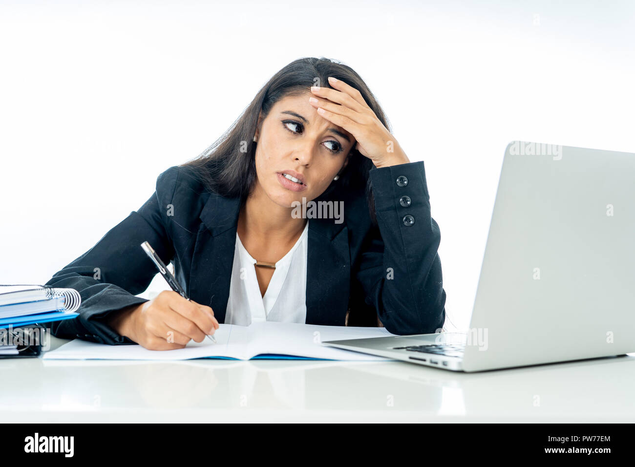 Young attractive businesswoman desperate and frustrated working on computer laptop at office in overtime and non fulfillment of ones hopes or professi Stock Photo