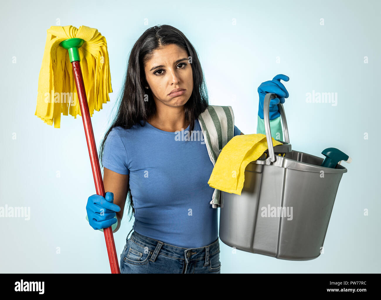 Young beautiful angry and upset housewife woman holding bucket mop cleaning  spray feeling sad frustrated and lazy in domestic duties concept isolated  Stock Photo - Alamy