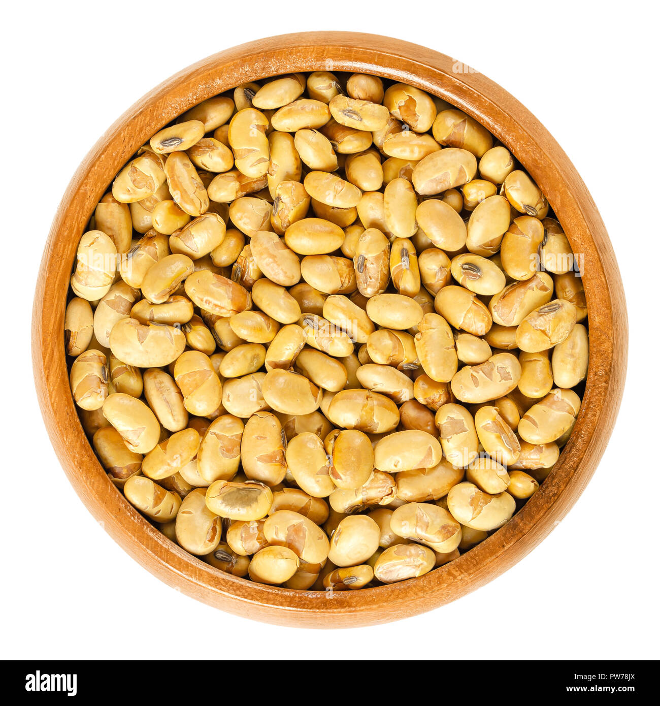 Roasted soybeans in wooden bowl. Dried, yellow soya beans, crispy roasted and slightly salted, used as snack. Rich in protein. Legume. Stock Photo